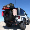 white tricked out jeep with spare tire rack gas & water cans supplies and M240 air compressor